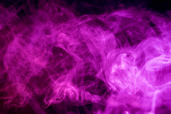 Dense pink smoke on a black isolated background. Background of smoke vape