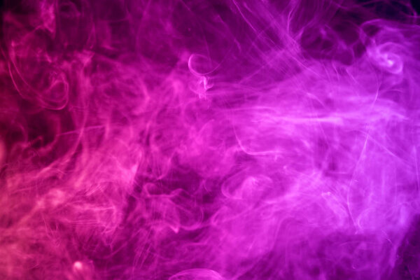 Thick pink smoke on a black isolated background. Background from the smoke of vap