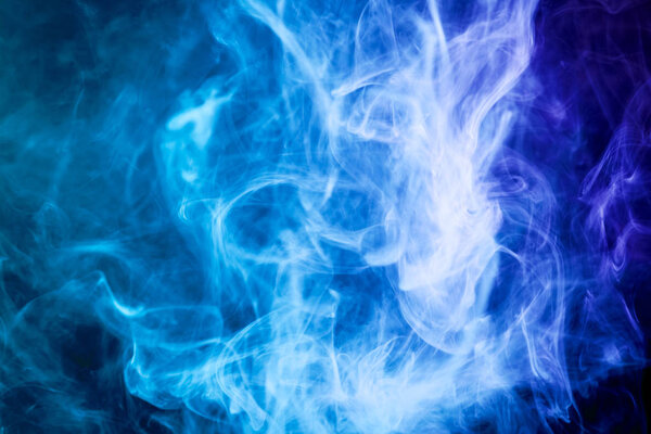 Cloud of blue smoke on a black isolated background. Background from the smoke of vap