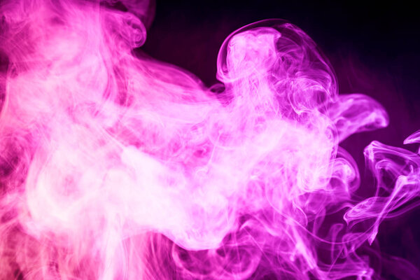 Cloud of pink smoke on a black isolated background. Background from the smoke of vap
