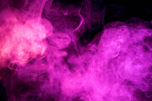 Thick colorful pink smoke on a black isolated background. Background from the smoke of vap