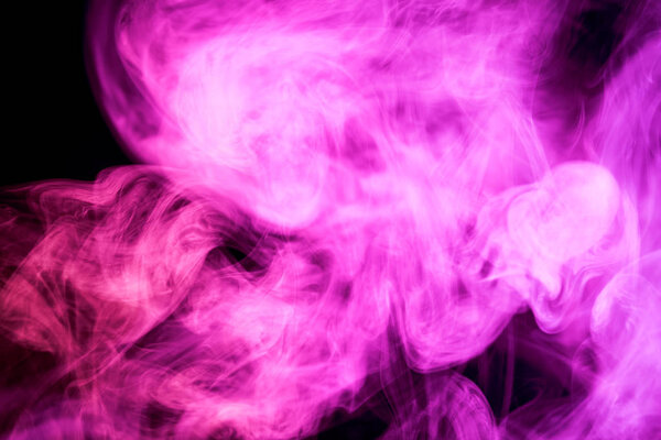 Colorful pink smoke on a black isolated background. Background from the smoke of vap