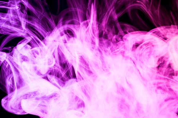 Colorful purple smoke on a black isolated background. Background from the smoke of vape