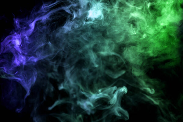 Thick green, blue smoke on a black isolated background. Background from the smoke of vap