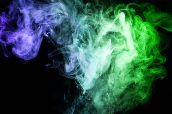 Thick green, blue smoke on a black isolated background. Background from the smoke of vap