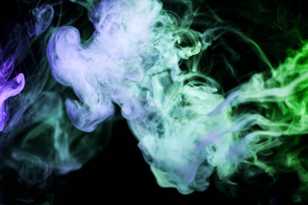 Cloud of blue,green smoke on a black isolated background. Background from the smoke of vap