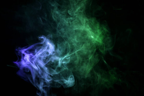 Cloud of blue,green smoke on a black isolated background. Background from the smoke of vap