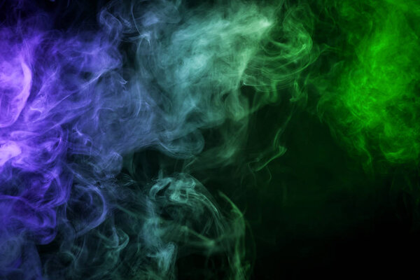 Green and blue cloud smoke on black isolated backgroun