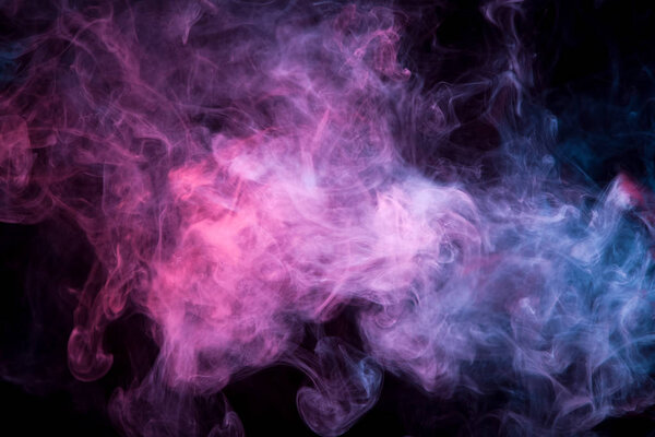 Cloud of  orange, pink and purple smoke on a black isolated background. Background from the smoke of vap