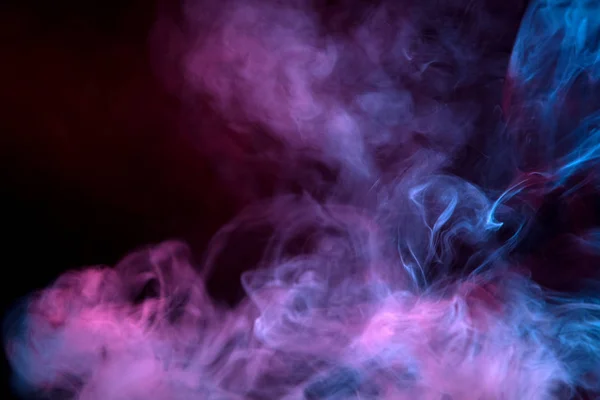 Cloud of  pink and purple smoke on a black isolated background. Background from the smoke of vap