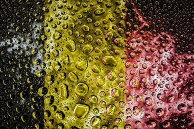 Bir damla su Belçika ulusal bayrak izole bir arka plan üzerinde çerçevede bir close-up