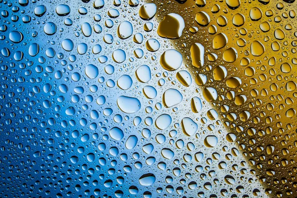 Yakın up bir su damlaları bir mavi ve kaplı kahverengi degrade arka plan damla su - yoğunlaşma.