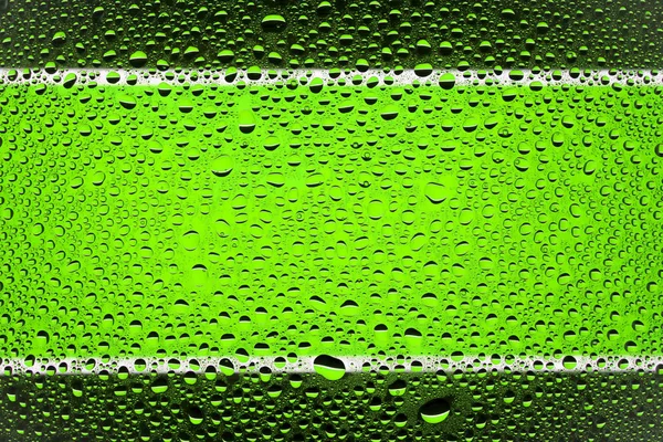 Close up of a water drops on a black and green  striped background, covered with drops of water -condensation.