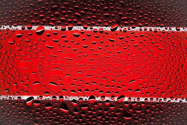 Close up of a water drops on a black and red  striped background, covered with drops of water -condensation.