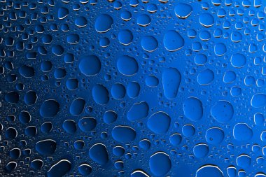 Yakın yukarı bir su damlaları bir siyah ve mavi degrade arka plan ile kaplı, damla su - yoğunlaşma.