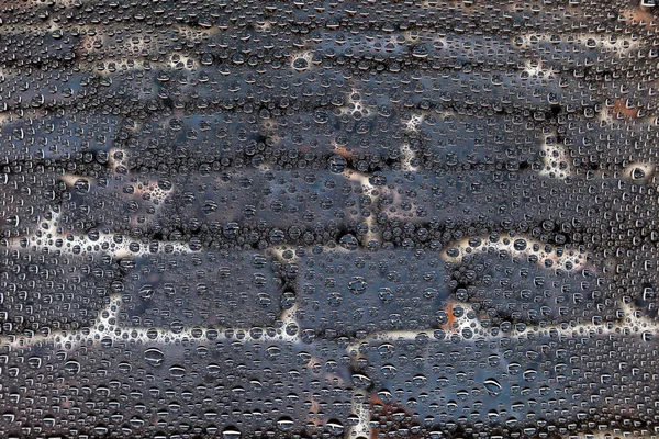 Close up of a water drops on the gray stone floorbackground, covered with drops of water -condensation.