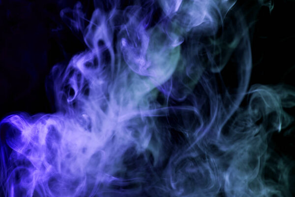 Colorful blue smoke on a black isolated background. Background from the smoke of vap