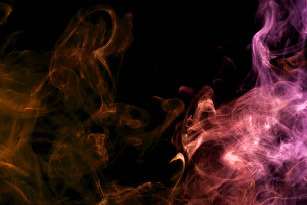 Dense multicolored smoke of pink, orange and purple colors on a black isolated background. Background of smoke vap
