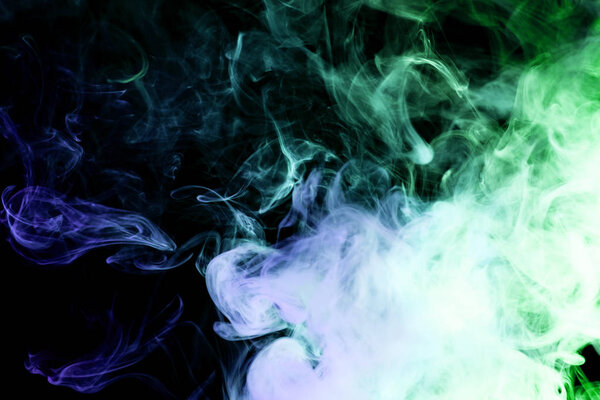 Blue and green smoke on a black isolated background. Background from the smoke of vape