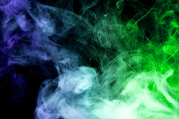 Cloud of blue and green smoke on a black isolated background. Background from the smoke of vap