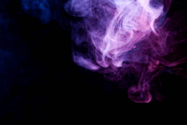 Purple smoke on a black isolated background. Background from the smoke of vape