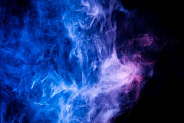 Colorful pink and blue smoke on a black isolated background. Background from the smoke of vap