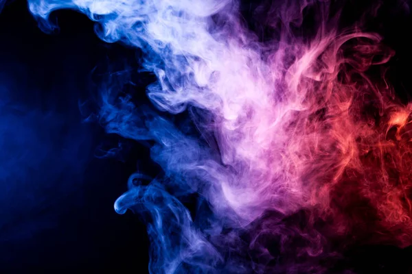 Blue and purple cloud of smoke of  black isolated background. Background from the smoke of vap