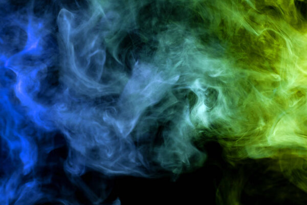 Cloud of blue, green smoke on a black isolated background. Background from the smoke of vap