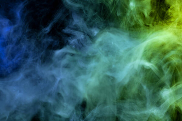 Green, yellow and blue cloud smoke on black isolated backgroun