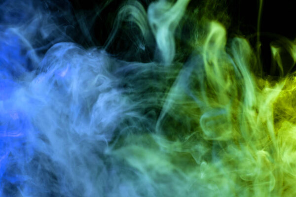 Green, yellow and blue cloud smoke on black isolated backgroun