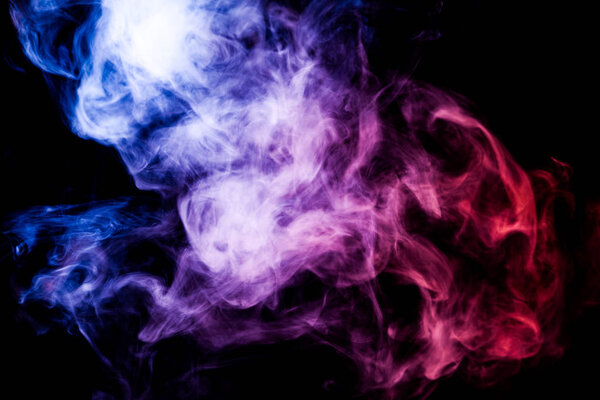 Dense purple, pink and blue smoke on a black isolated background. Background of smoke vap