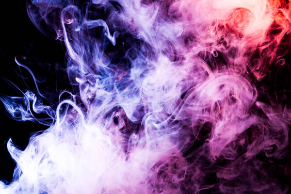 Cloud of pink, purple, blue smoke on a black isolated background. Background from the smoke of vap