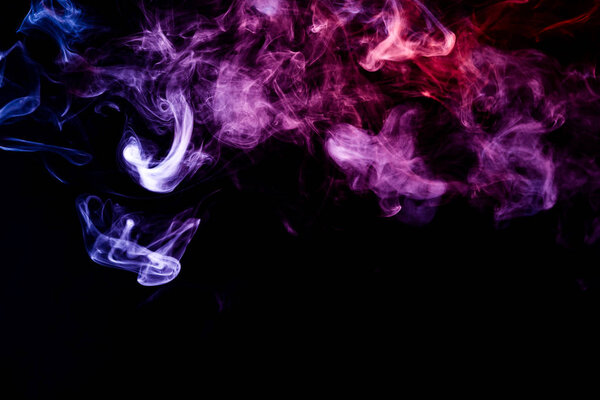 Cloud of pink, purple, blue smoke on a black isolated background. Background from the smoke of vap