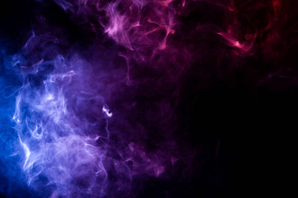 Thick blue and pink smoke on a black isolated background. Background from the smoke of vap