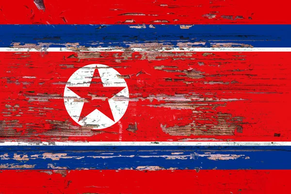 National flag of North Korea on a dull wooden background