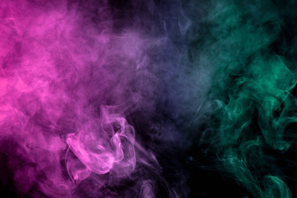 Dense pink, green and white smoke on a black isolated background. Background of smoke vap