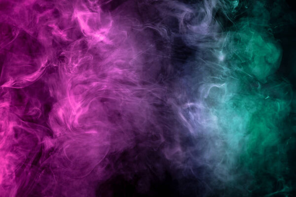 Thick green, pink and white smoke on a black isolated background. Background from the smoke of vap