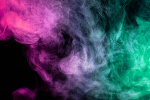 Cloud of green, pink and white smoke on a black isolated background. Background from the smoke of vap