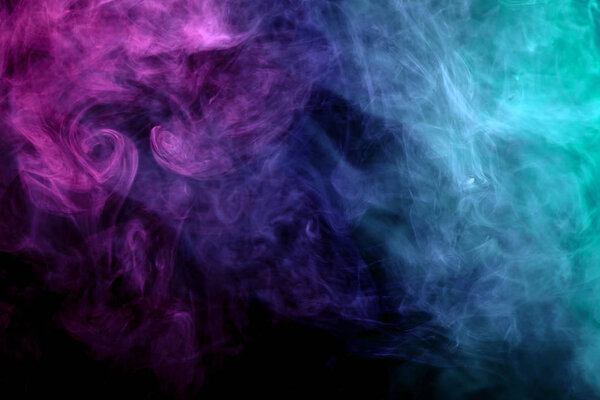 Cloud of pink, red and blue smoke on a black isolated background. Background from the smoke of vap