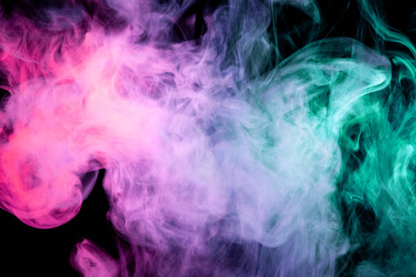 Cloud of pink, red and blue smoke on a black isolated background. Background from the smoke of vap