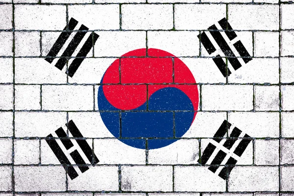 National flag of South Korea  against a background of a stone background covered with moss