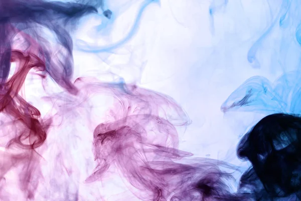 Cloud of pink, red and blue smoke on a white isolated background. Background from the smoke of vap