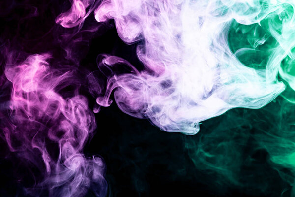 Blue, green and pink smoke on black background