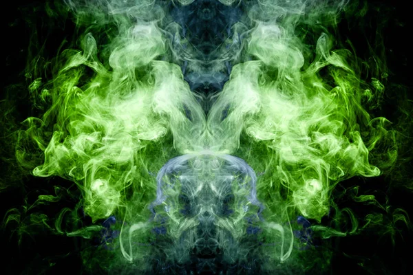 Fantasy print for clothes: t-shirts, sweatshirts.  Colorful blue and green smoke in the form of a skull, monster, dragon on a black isolated background. Background from the smoke of vap