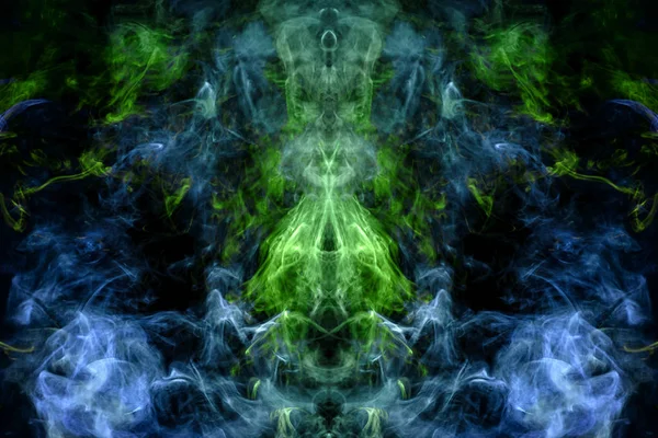 Fantasy print for clothes: t-shirts, sweatshirts.  Colorful blue and green smoke in the form of a skull, monster, dragon on a black isolated background. Background from the smoke of vap