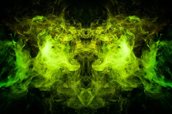 Fantasy print for clothes: t-shirts, sweatshirts. Green and yellow cloud of smoke in the form of a monster  of  black isolated background. Background from the smoke of vape.