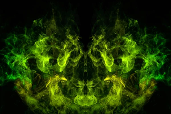 Fantasy print for clothes: t-shirts, sweatshirts. Green and yellow cloud of smoke in the form of a monster  of  black isolated background. Background from the smoke of vape.