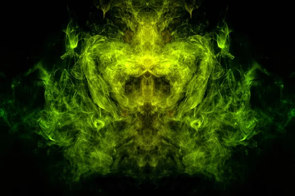 Fantasy print for clothes: t-shirts, sweatshirts.  Colorful yellow and green smoke in the form of a skull, monster, dragon on a black isolated background. Background from the smoke of vap