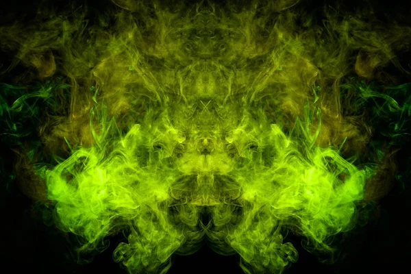 Fantasy print for clothes: t-shirts, sweatshirts. Thick colorful smoke of yellow, green colors smoke in the form of a skull, monster, dragon on a black isolated background. Background from the smoke of vap