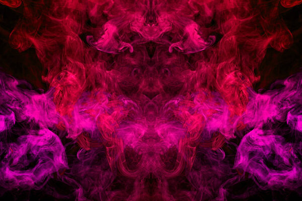Fantasy print for clothes: t-shirts, sweatshirts. Thick colorful smoke of pink, red colors smoke in the form of a skull, monster, dragon on a black isolated background. Background from the smoke of vap